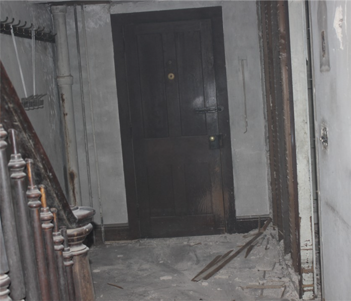 Door and hallway with severe fire damage.