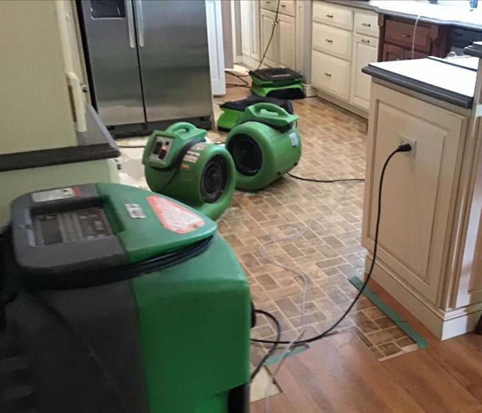 Drying equipment on kitchen floor.